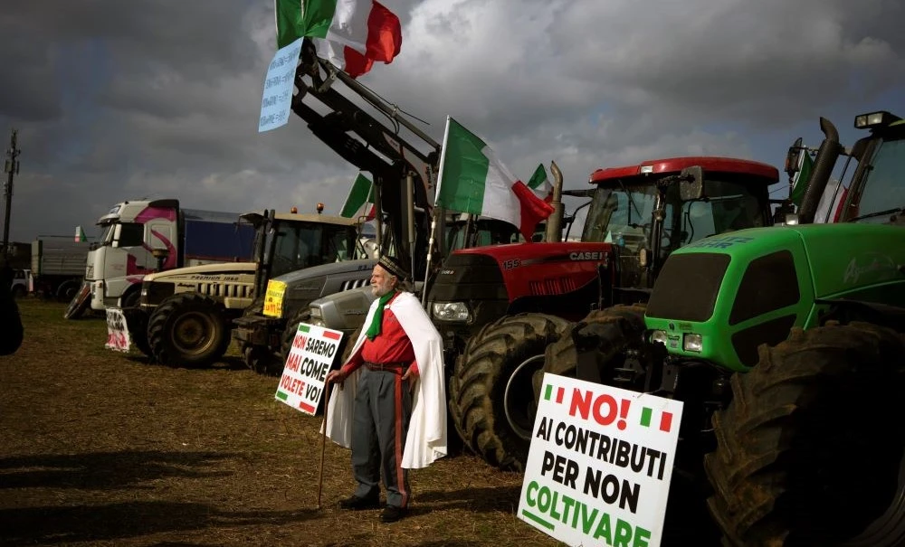 A man dressed as Giuseppe Garibaldi stands in front of farmers’ tractors on the outskirts of Rome, Feb. 8, 2024. (AP Photo)