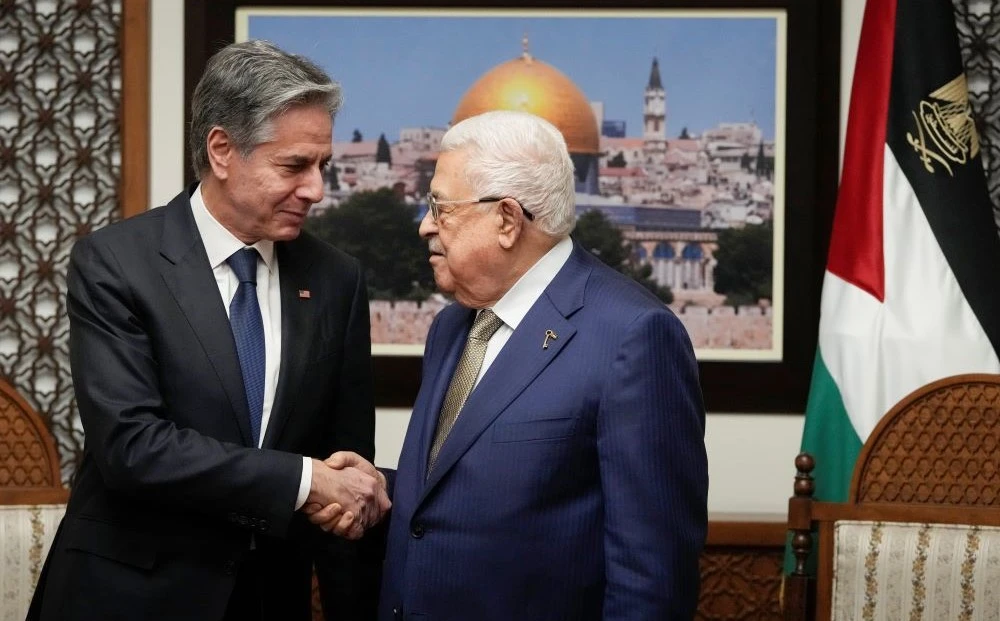 Antony Blinken and Mahmoud Abbas shake hands as they meet in the West Bank town of Ramallah, Feb. 7, 2024. (AP Photo)