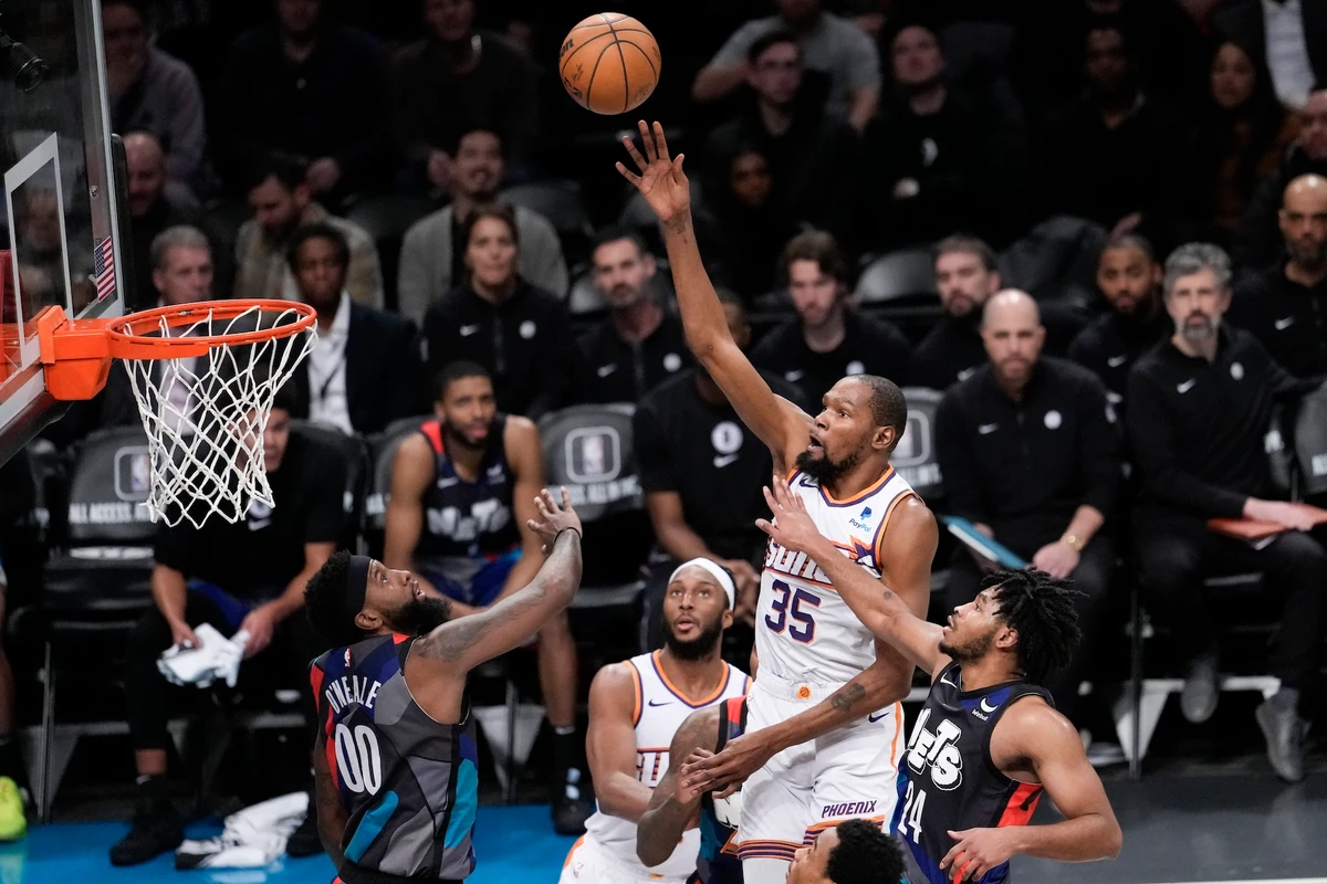 Phoenix Suns forward Kevin Durant goes to the basket against Brooklyn Nets guard Cam Thomas (24) and forward Royce O'Neale (00) during the second half of an NBA basketball game Wednesday in New York. The Suns won 136-120. (AP)