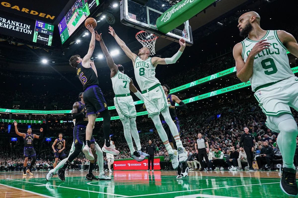 Los Angeles Lakers guard Austin Reaves shoots against Boston Celtics center Kristaps Porzingis (8) and guard Jaylen Brown (7) in the first half of an NBA game at TD Garden Thursday. (USA TODAY Sports)