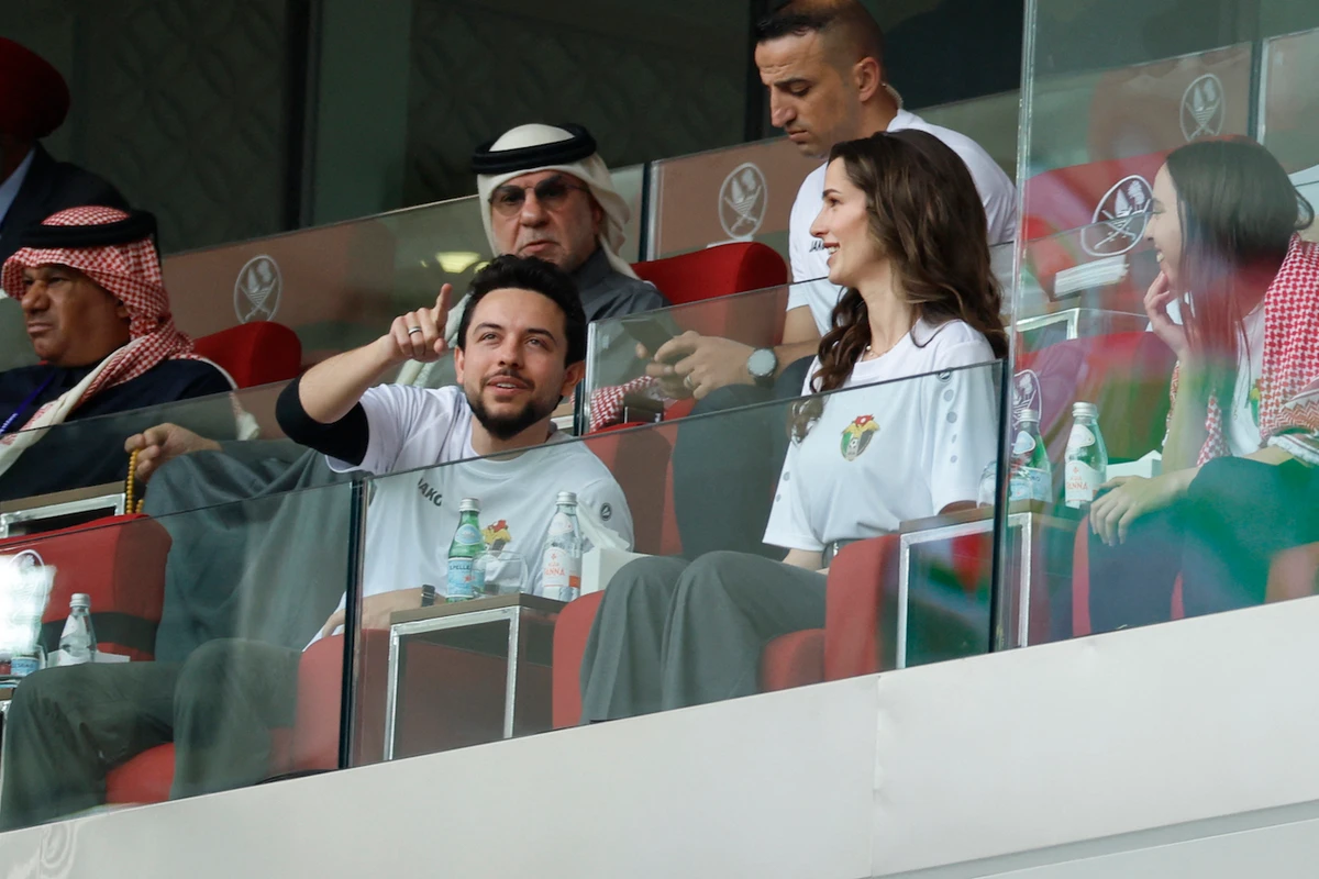 Princess Rajwa — accompanied by her husband Crown Prince Hussein bin Abdullah — wore the jersey of Jordan’s national team, paired with grey straight-leg trousers and a matching belt. (Getty Images)