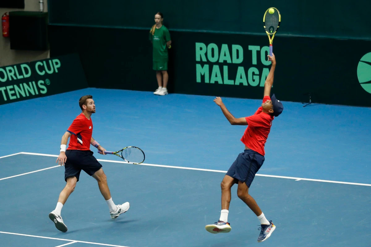 Rajeev Ram of the US, right, returns a ball next to his teammate Austin Krajicek during their match against Illya Beloborodko and Oleksii Krutykh of Ukraine during a Davis Cup qualifier doubles tennis match between Ukraine and US, in Vilnius, Lithuania, on Friday. (AP)