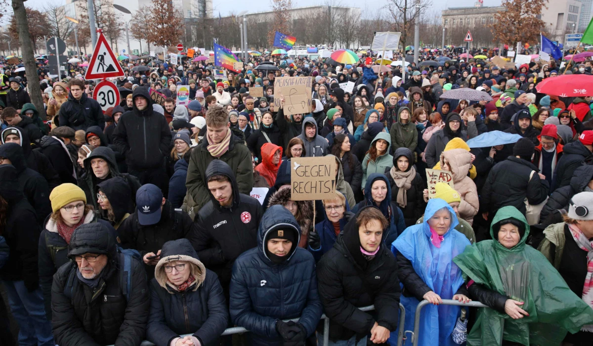 Demonstrators protest against the far-right Alternative for Germany (AfD) party outside the Reichstag building in Berlin, Germany on February 3, 2024, during a rally under the motto 'We are the firewall' called for by international non-profit organisation 'Hand in Hand' to protest against right-wing politics. (AFP)