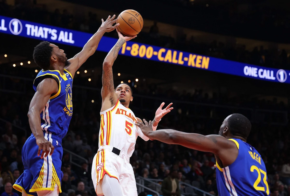 Dejounte Murray of the Atlanta Hawks attempts a shot against Andrew Wiggins and Draymond Green #23 of the Golden State Warriors during the first quarter of an NBA game at State Farm Arena on Feb. 3, 2024 in Atlanta, Georgia. (AFP)