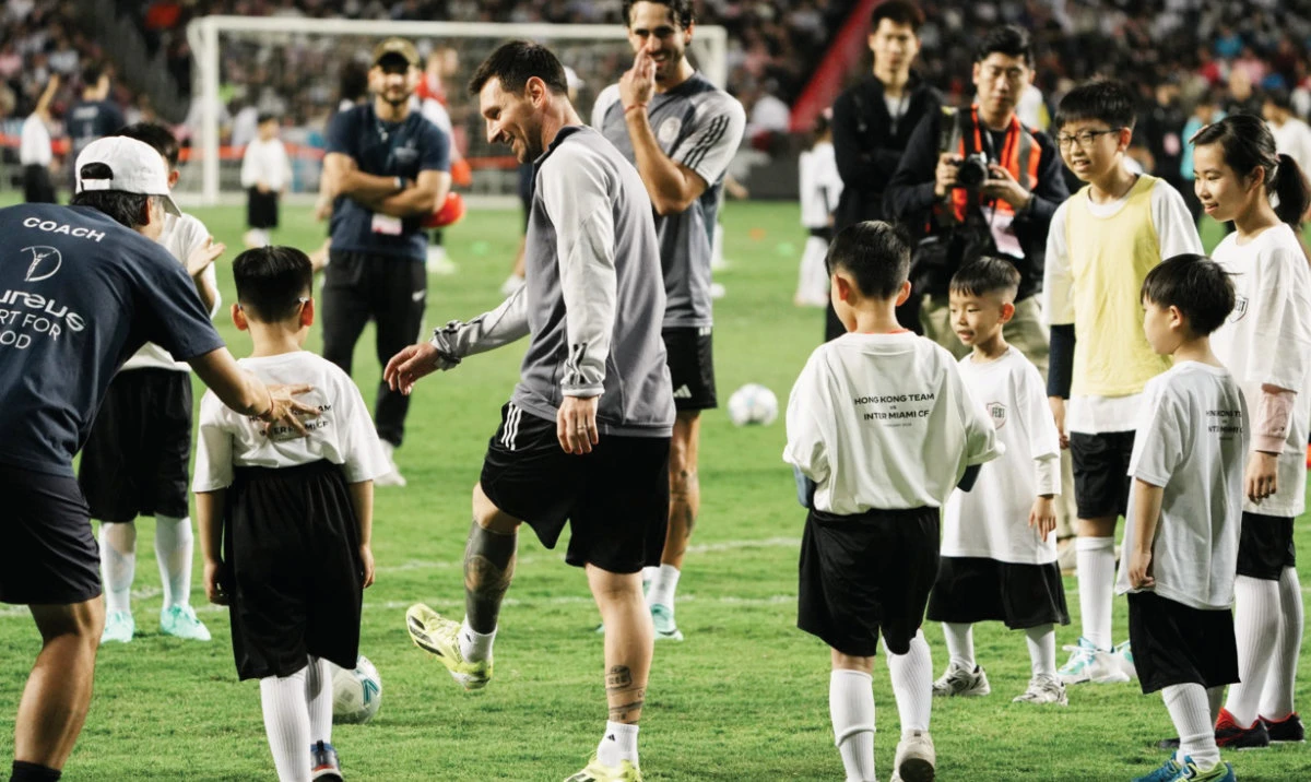 Inter Miami’s Lionel Messi plays football with children during training in Hong Kong on Saturday. (Reuters)
