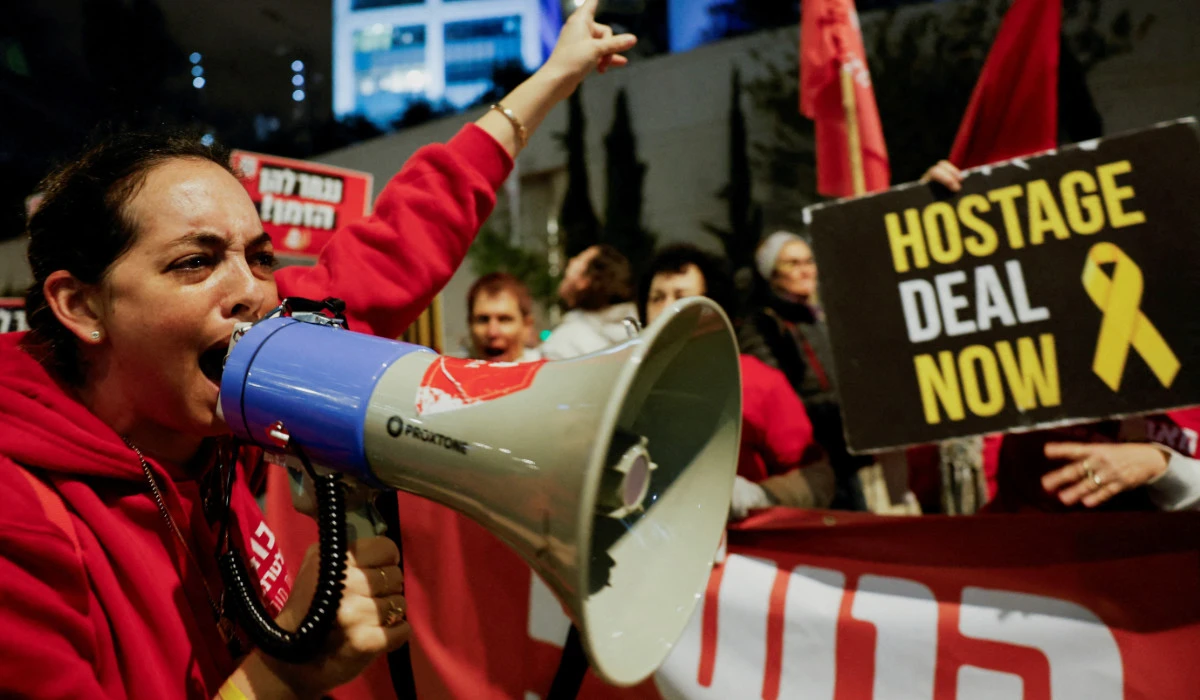 A woman uses a megaphone during a protest held by families of hostages and supporters to call for the release of hostages in Tel Aviv. (Reuters)