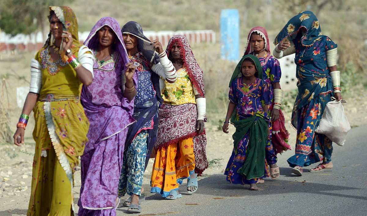 Photo: In this file photo, taken on March 11, 2014, Pakistani villagers walk alongside the road in Mithi, the capital of Tharparkar district, some 300 kilometres from Karachi. (AFP/File)