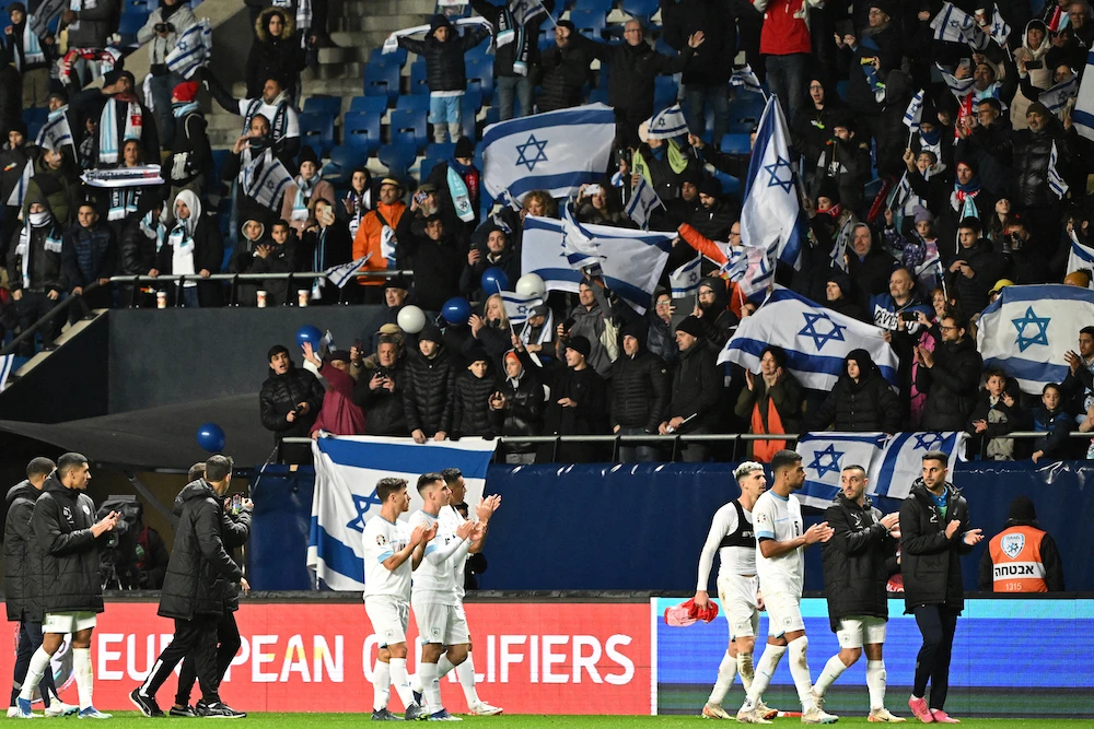 Israel’s players applaud their fans after the UEFA Euro 2024 Group I qualification football match Israel versus Switzerland in Hungary on Nov. 15, 2023. (AFP)
