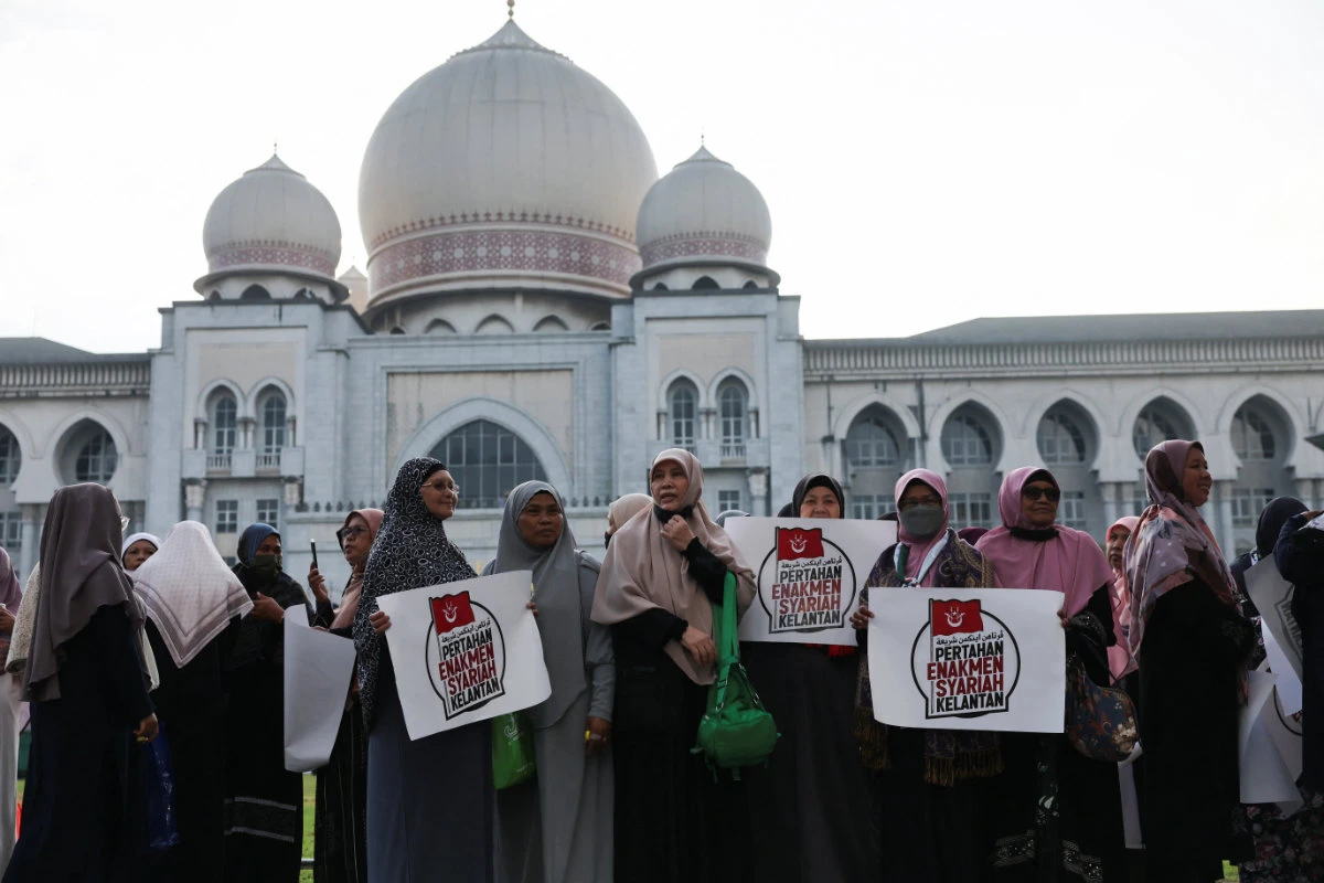 Malaysian women protest outside the Palace of Justice in Putrajaya on February 9, 2024, as the country's federal court delivers verdict in a constitutional case challenging the legality of some Islamic laws in Kelantan state. (Reuters)