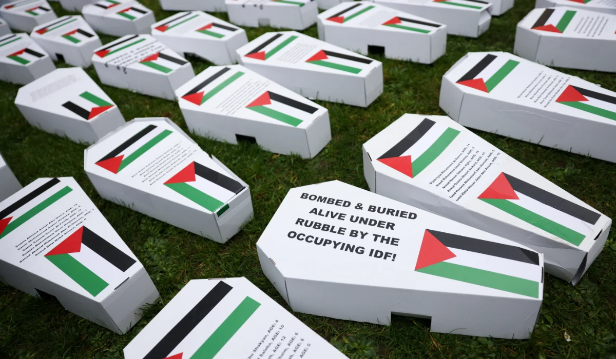 Mock coffins with Palestinian flags lay on the grass as demonstrators gather for a vigil for Gaza, amid the ongoing conflict between Israel and the Palestinian Islamist group Hamas, in London, Britain February 10, 2024. (REUTERS)