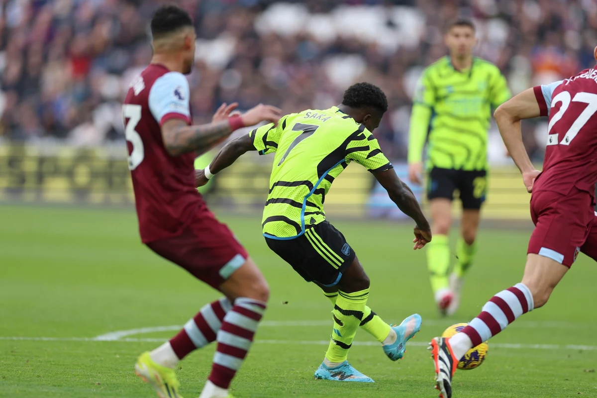 Arsenal's Bukayo Saka shoots and scores his side's 5th goal of the game during the English Premier League soccer match between West Ham United and Arsenal at the London Stadium in London Sunday. (AP)
