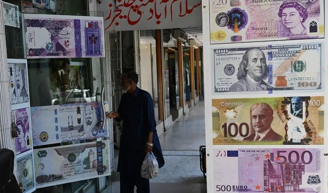 A man enters a foreign currency exchange shop in Islamabad on July 11, 2023. (AFP/File)