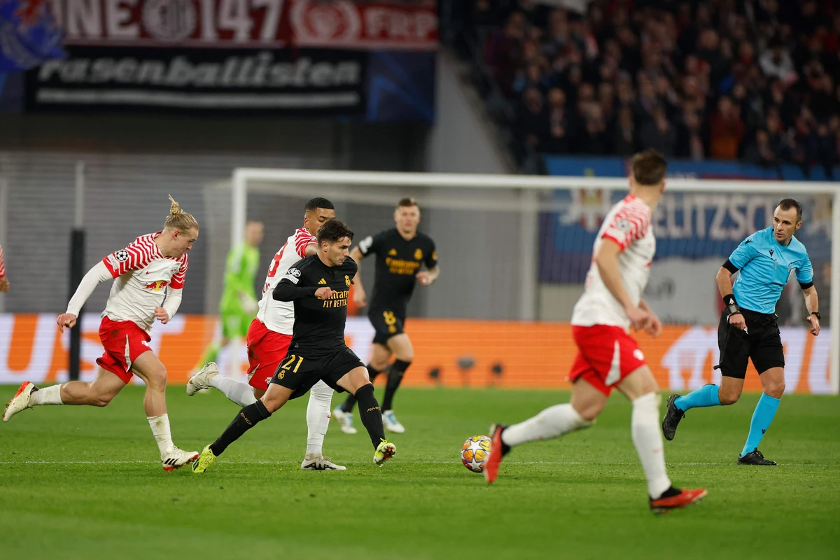 Real Madrid's Spanish forward #21 Brahim Diaz (C) gets away from the Leipzig duo of Austrian midfielder #24 Xaver Schlager (L) and German defender #39 Benjamin Henrichs during their UEFA Champions League round of 16 first-leg match in Leipzig on Feb. 13, 2024. (AFP)