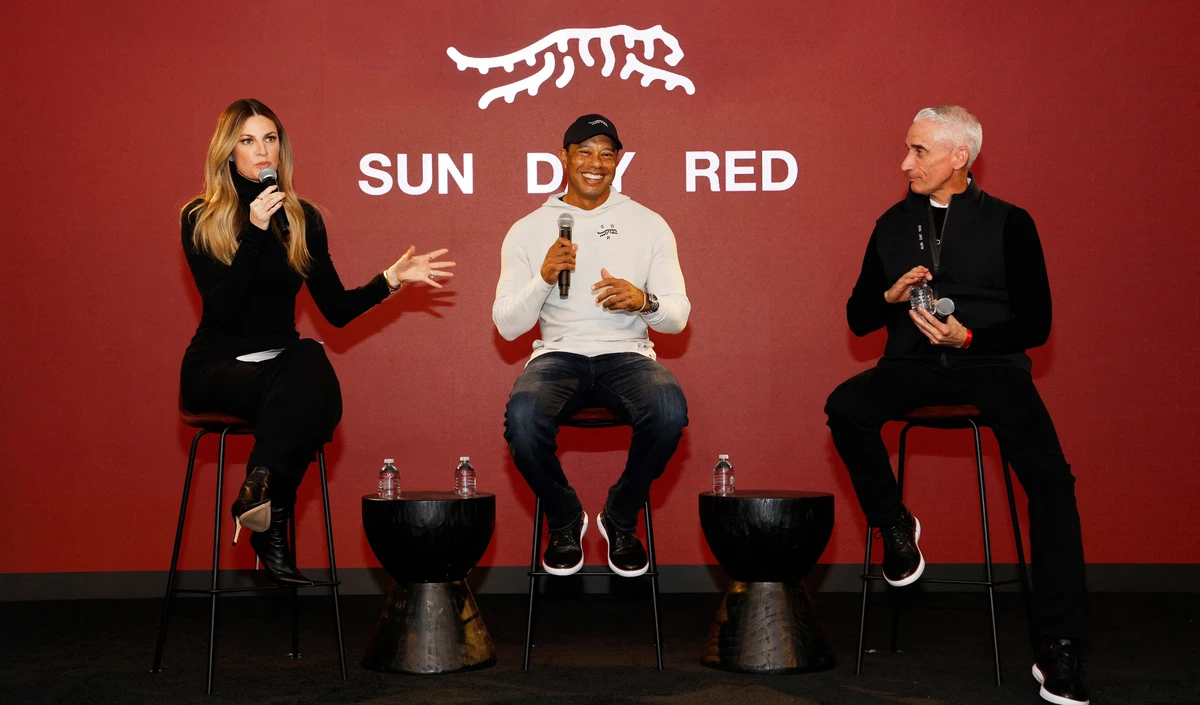 (L-R) Erin Andrews, Tiger Woods and CEO and president at TaylorMade, David Abeles, attend the launch of Tiger Woods and TaylorMade Golf's new apparel and footwear brand "Sun Day Red" at Palisades Village on Feb. 12, 2024 in Pacific Palisades, California. (GETTY IMAGES NORTH AMERICA /AFP)