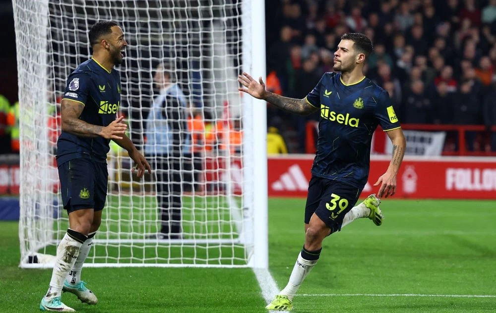 Newcastle United’s Bruno Guimaraes, right, celebrates with Callum Wilson after scoring against Nottingham Forrest at the City Ground, Nottingham, England, Feb. 10, 2024. (Reuters)