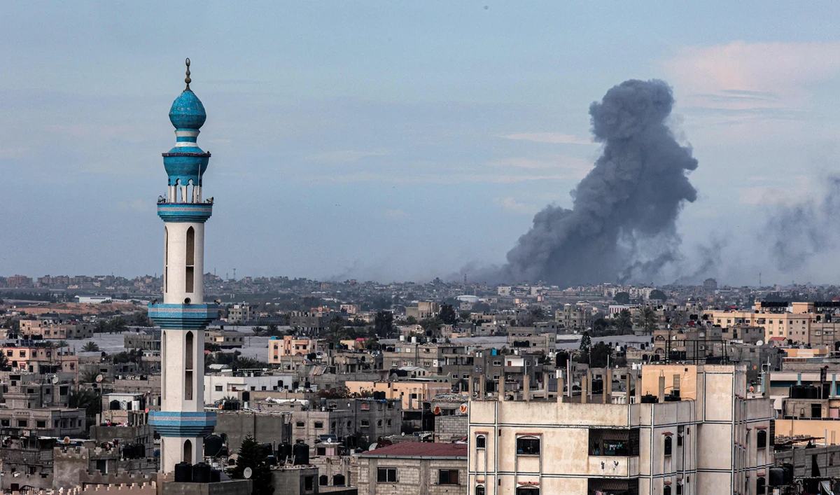 This picture taken from Rafah shows smoke billowing over Khan Yunis in the distance following Israeli bombardment on the southern Gaza Strip on February 14, 2024, amid the ongoing conflict between Israel and the Palestinian Hamas group. (AFP)