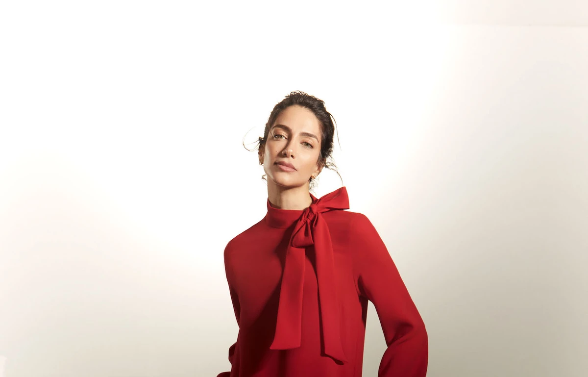 Her initial look features a striking floor-length chiffon dress in a vibrant red hue. (Supplied)