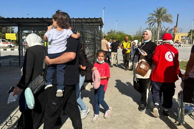 People cross into Egypt’s Rafah border crossing with the Gaza Strip on Nov. 9, 2023. (File/AFP)