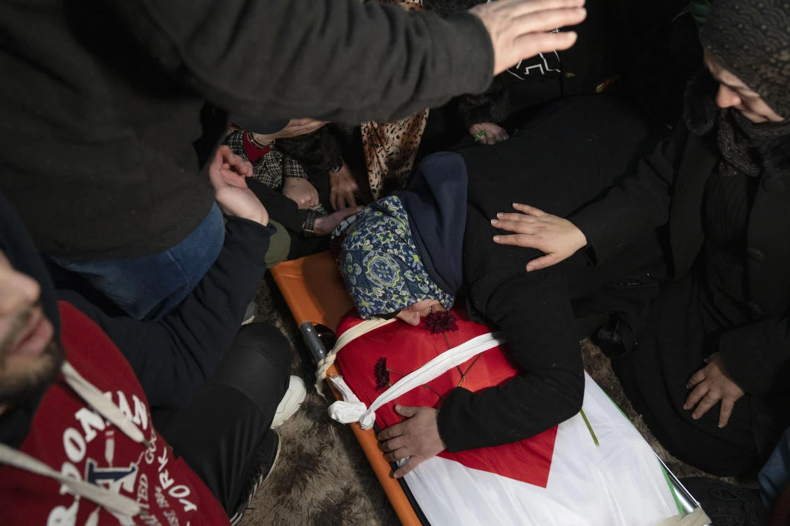 Hanan Issa Khdour, mother of Mohammad Khdour, 17, cries over the body of her son at the family house during his funeral in the West Bank village of Biddu, southwest of Ramallah, on Feb. 12, 2024. (AP)