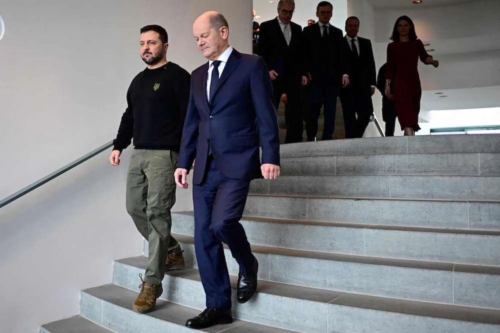 German Chancellor Olaf Scholz (R) and Ukraine's President Volodymyr Zelensky arrive with ministers to sign a bilateral security agreement the Chancellery, on February 16, 2024 in Berlin, Germany. (AFP)
