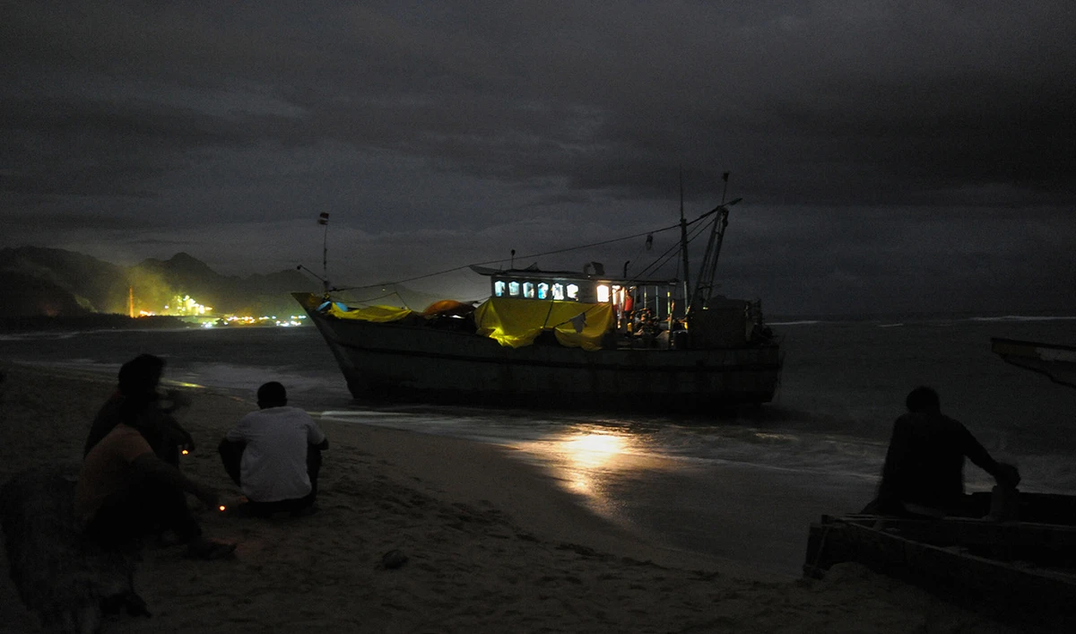 This picture taken on June 14, 2016 shows a night shot of a boat of migrants reportedly headed from Sri Lanka to Australia. (AFP/File)