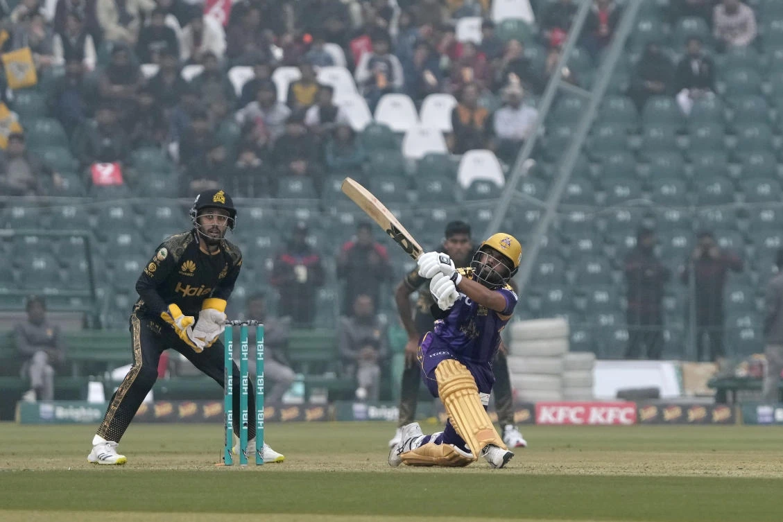 Quetta Gladiators' Saud Shakeel, right, plays a shot for six as Peshawar Zalmi' Mohammad Haris watches during the Pakistan Super League T20 cricket match. (AP)