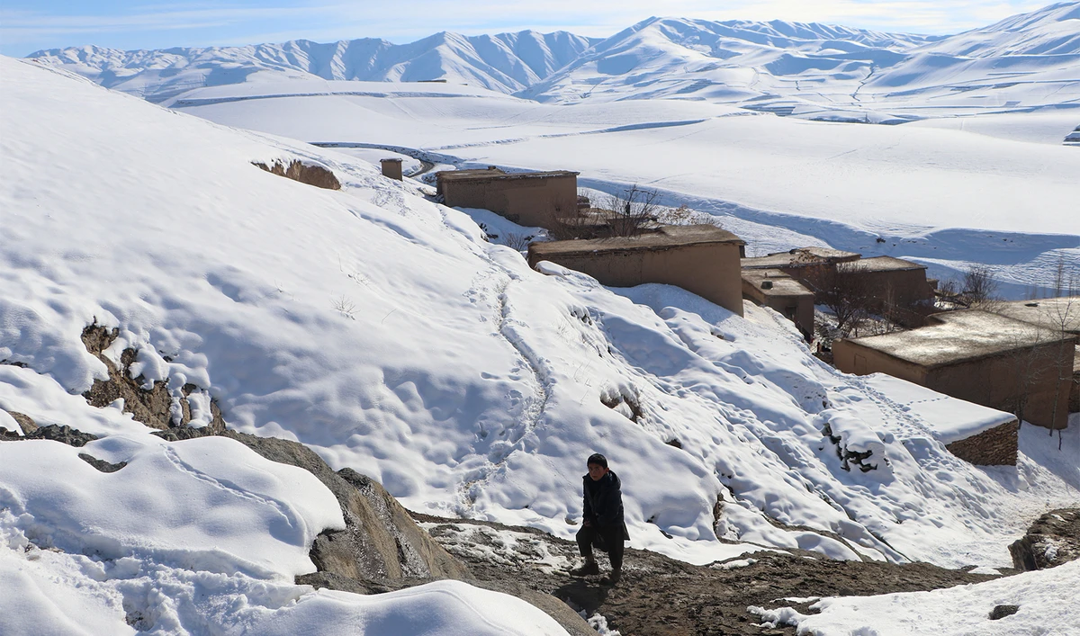 An Afghan boy walks up a snow laden path in Argo district of Badakhshan province on February 5, 2024. (AFP/File)