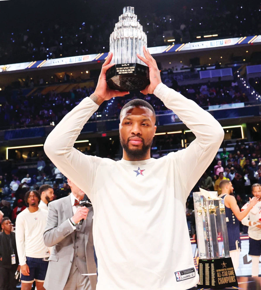 Eastern Conference guard Damian Lillard of the Milwaukee Bucks holds up the MVP trophy after winning the 73rd NBA All Star game at Gainbridge Fieldhouse on Sunday. (Reuters)