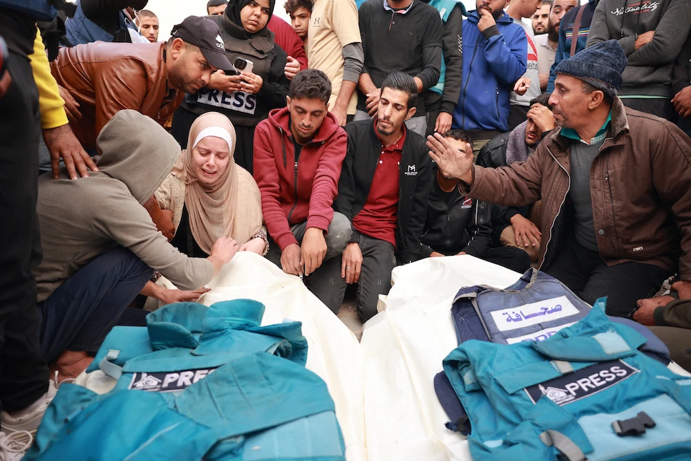 At least 126 people working in the press and media sector have died since Israel began military operations in Gaza. Above, relatives and colleagues of Hasouna Slim and Sari Mansoor, who were killed in an Israeli strike, mourn during the Palestinian journalists’ funeral on Nov. 19, 2023. (AFP)