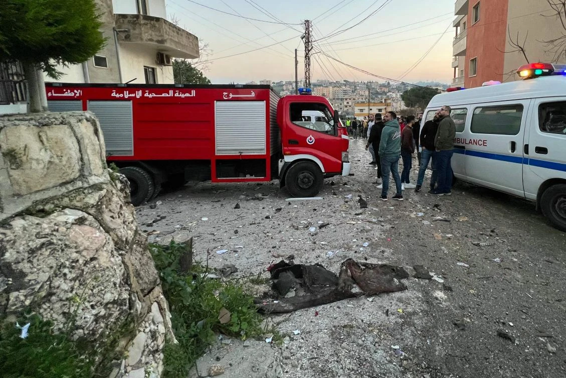 An ambulance and a fire engine rush to the scene where an Israeli drone shot two guided missiles at a building in Kfar Rumman near south Lebanon’s town of Nabatiyeh on Feb. 22, 2024. (AFP)