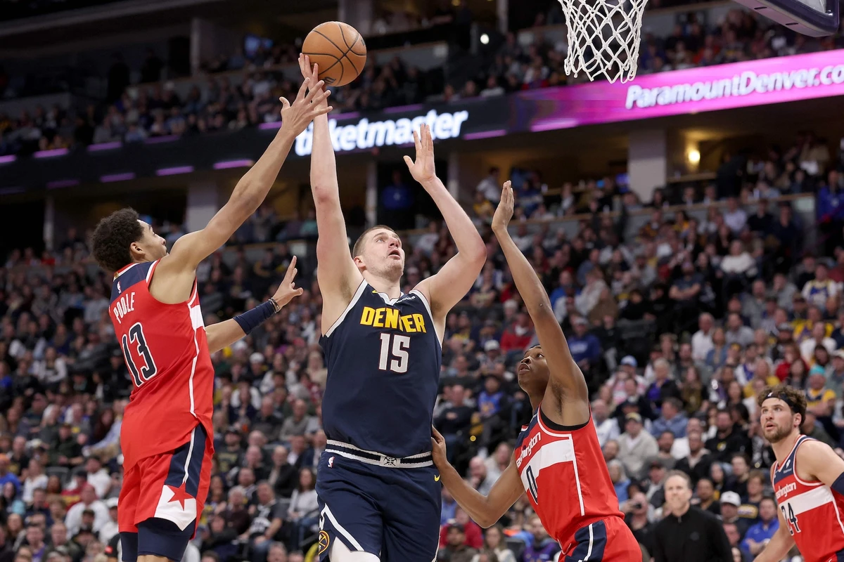 Nikola Jokic of the Denver Nuggets puts up a shot against Jordan Poole #13 and Bilal Coulibaly of the Washington Wizards in the fourth quarter of an NBA game at Ball Arena on Feb. 22, 2024 in Denver, Colorado. (AFP)