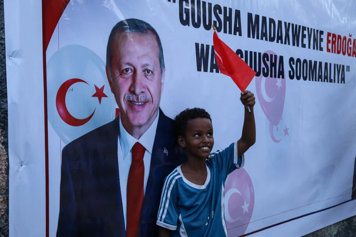 A Somali boy holds a Turkish national flag as people celebrate the victory of Turkish President Recep Tayyip Erdogan after he won the presidential run-off election in Mogadishu, on May 29, 2023.(AFP)