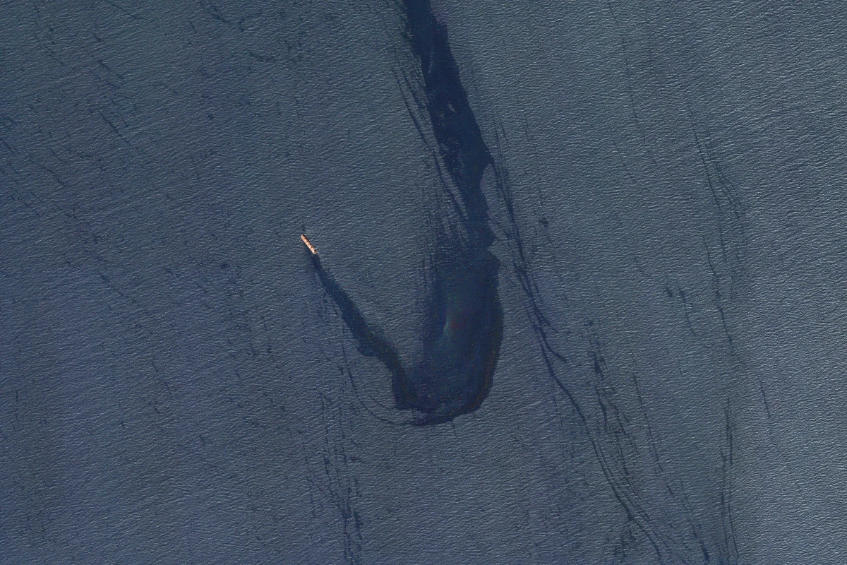 In this satellite image provided by Planet Labs, the Belize-flagged bulk carrier Rubymar is seen in the southern Red Sea near the Bay Al-Mandab Strait leaking oil after an attack by Yemen's Houthi militia on Feb. 20, 2024. (Planet Labs PBC via AP)