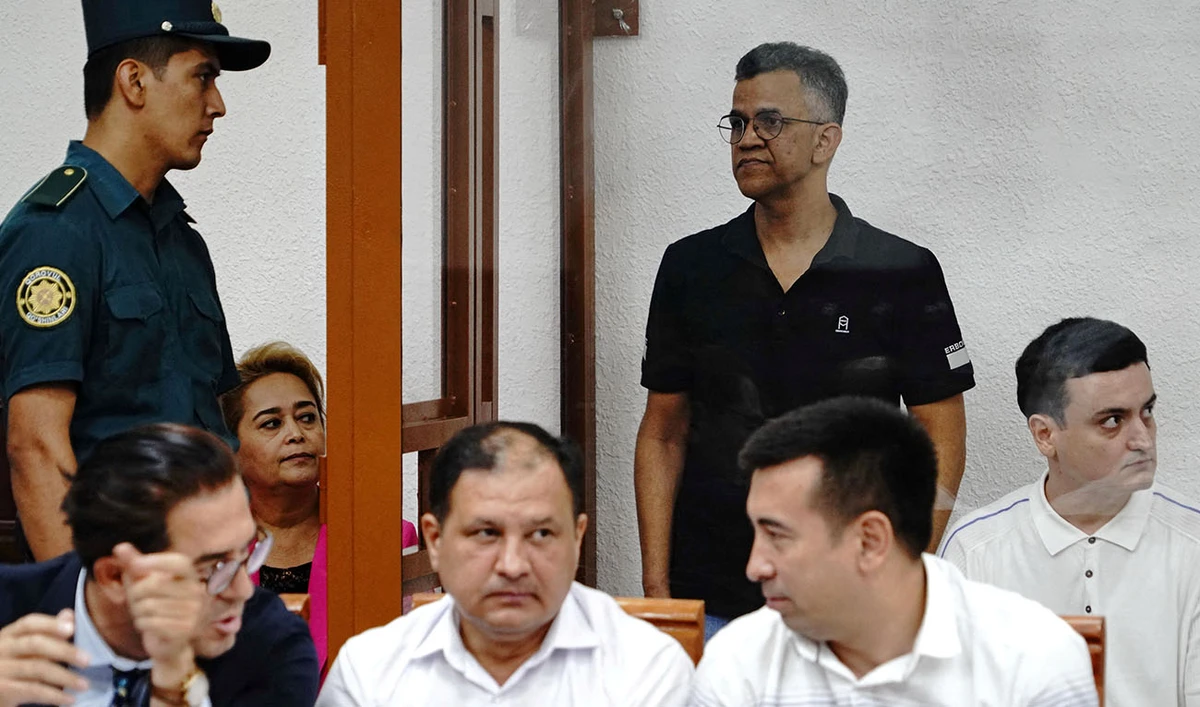 Defendant Singh Raghvendra Pratar, an executive of Quramax Medical, a company that sold medicines produced by India's Marion Biotech in Uzbekistan, stands inside an enclosure for defendants during a court hearing in the case of child deaths linked to contaminated cough syrups, in Tashkent, Uzbekistan August 16, 2023. (AFP)