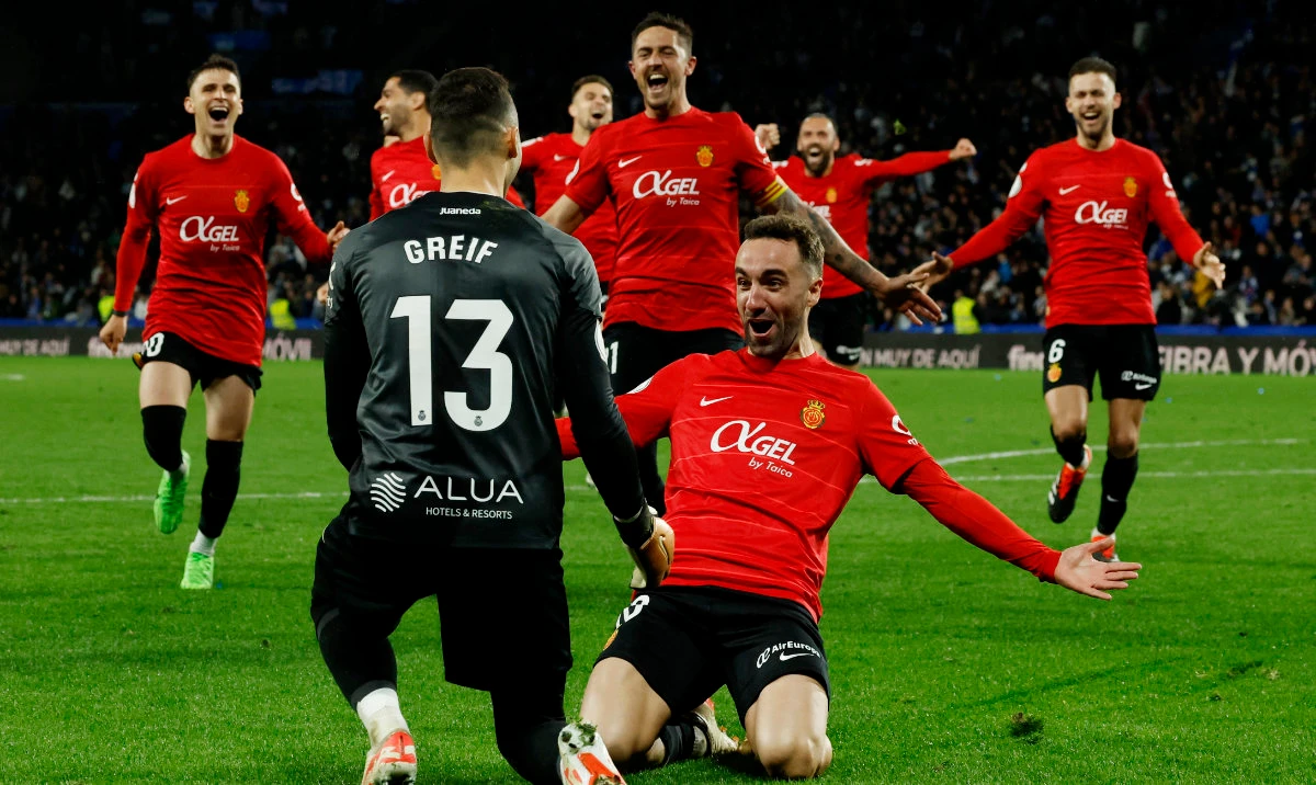 Mallorca's Dominik Greif and Sergi Darder celebrate after winning the penalty shoot-out on Tuesday during the Copa del Rey semifinal second leg between Real Sociedad and Mallorca at Reale Arena, San Sebastian, Spain. (Reuters)