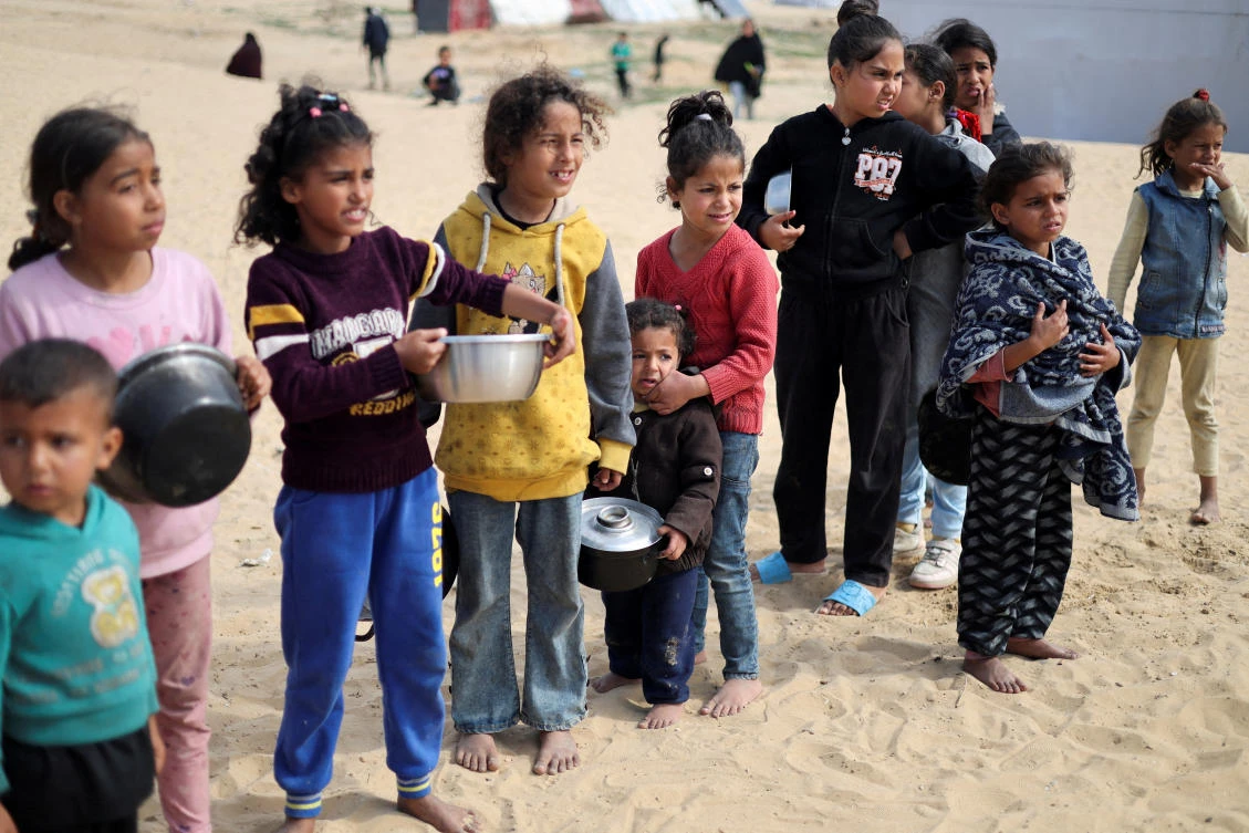 Displaced Palestinian children wait to receive free food at a tent camp, amid food shortages, as the conflict between Israel and Hamas continues, in Rafah in the southern Gaza Strip (REUTERS)