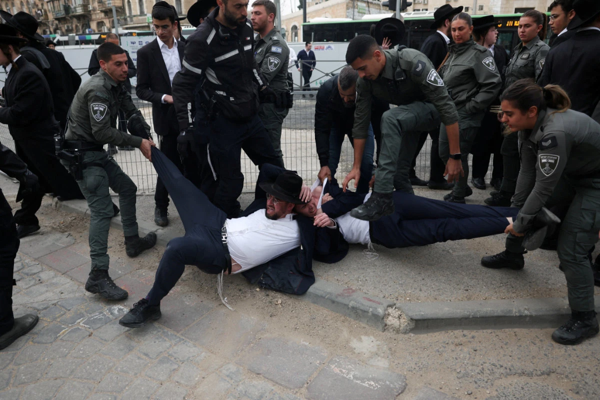 Members of the Israeli Border Police detain ultra-Ortodox Jewish men protest in Jerusalem on Feb. 26, 2024 against moves to change government policy that exempts them from military conscription. (Reuters)