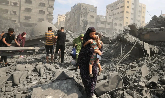 Palestinians evacuate the area following an Israeli airstrike on the Sousi mosque in Gaza City. (AFP)
