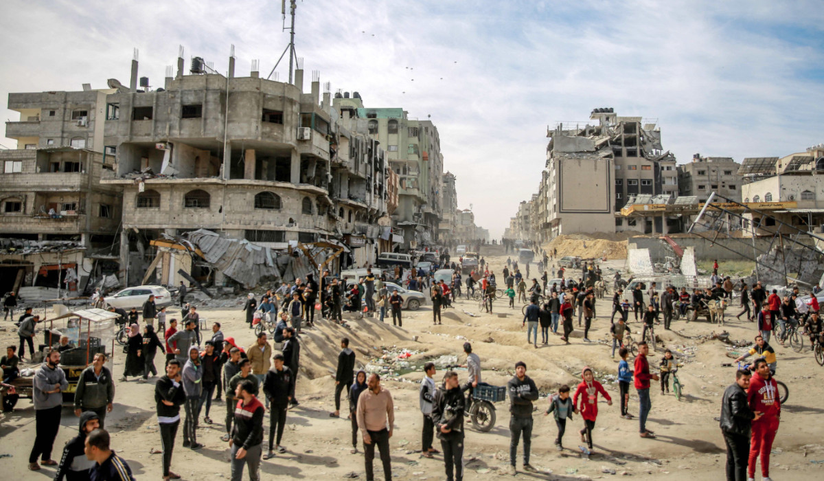 Palestinians gather in a street as humanitarian aid is airdropped in Gaza City on March 1, 2024, amid the ongoing conflict between Israel and the Hamas militant group. (AFP)
