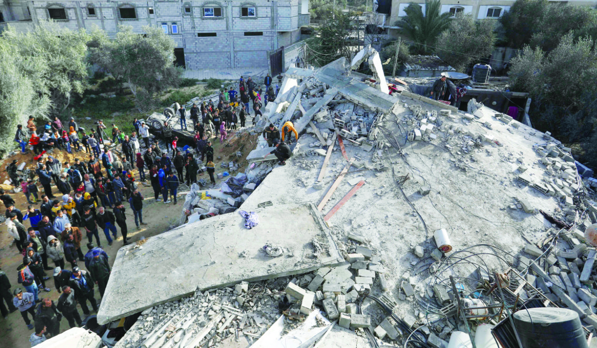 Palestinians check the rubble of a house destroyed in an Israeli airstrike in Rafah in the southern Gaza Strip on Sunday as the conflict between Israel and Hamas continues. (AFP)