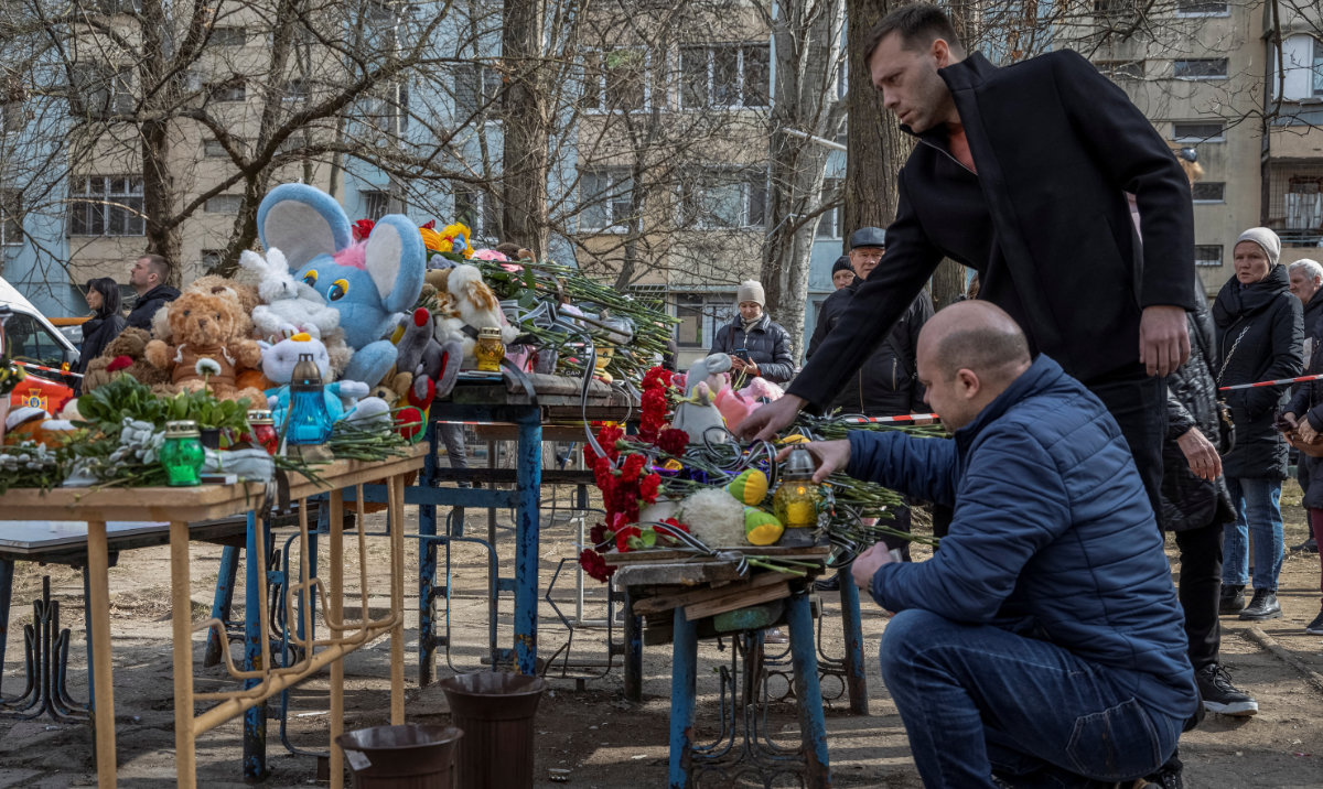 People light candles and lay flowers at a makeshift memorial to the victims of previous day's drone strike that heavily damaged apartment building, amid Russia's attack on Ukraine, in Odesa, Ukraine March 3, 2024. (Reuters)