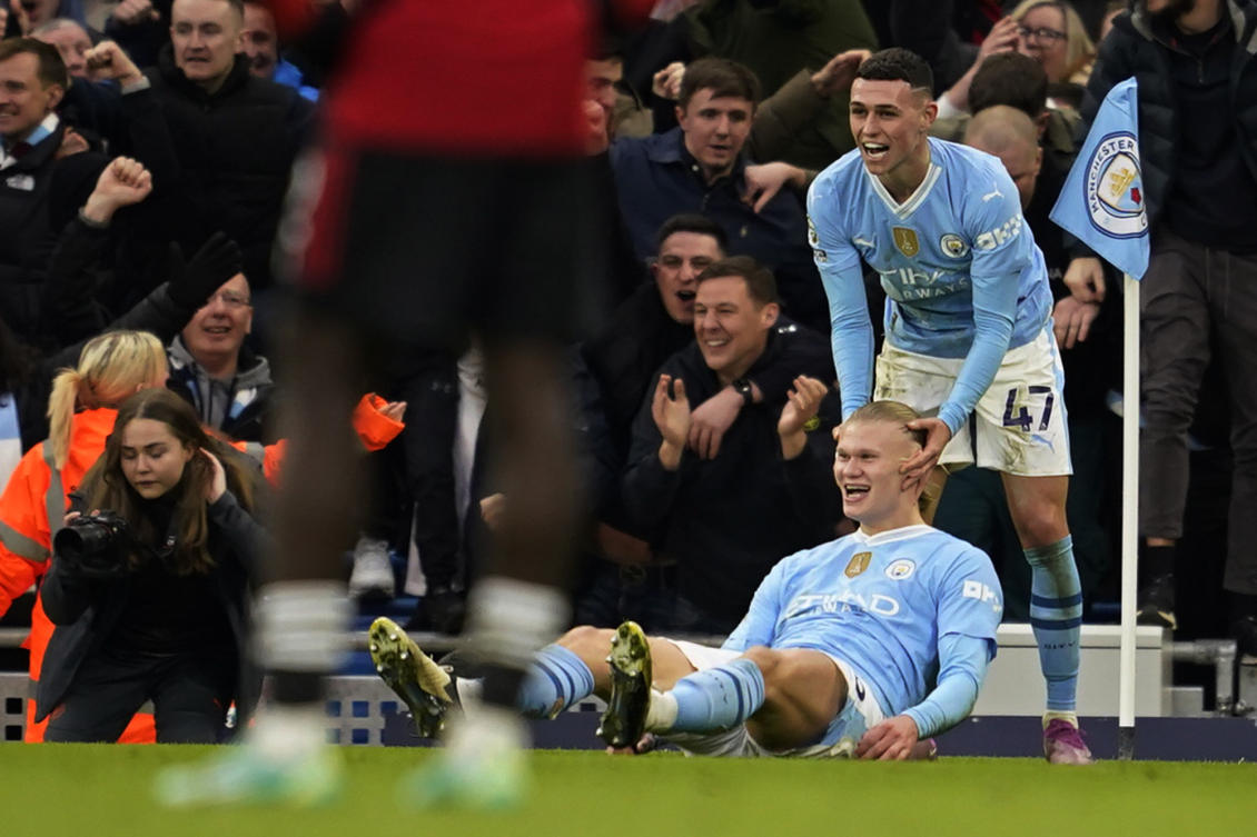 Manchester City’s Erling Haaland celebrates with Phil Foden, right, after scoring his side’s third goal during an English Premier League soccer match between Manchester City and Manchester United at the Etihad Stadium in Manchester, England, Sunday, March 3, 2024. (AP)