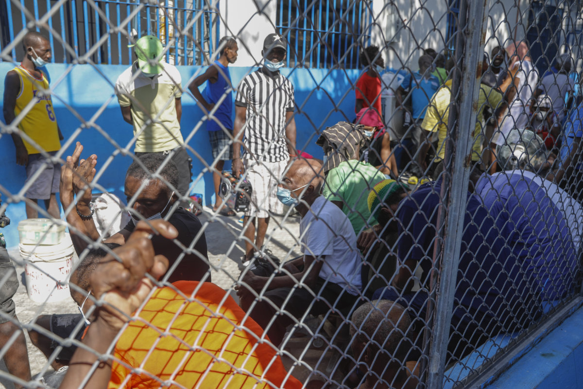 An inmate helps another prisoner inside the National Penitentiary in Port-au-Prince, Haiti, on March 3, 2024, after an overnight attack by armed gangs. (AP)