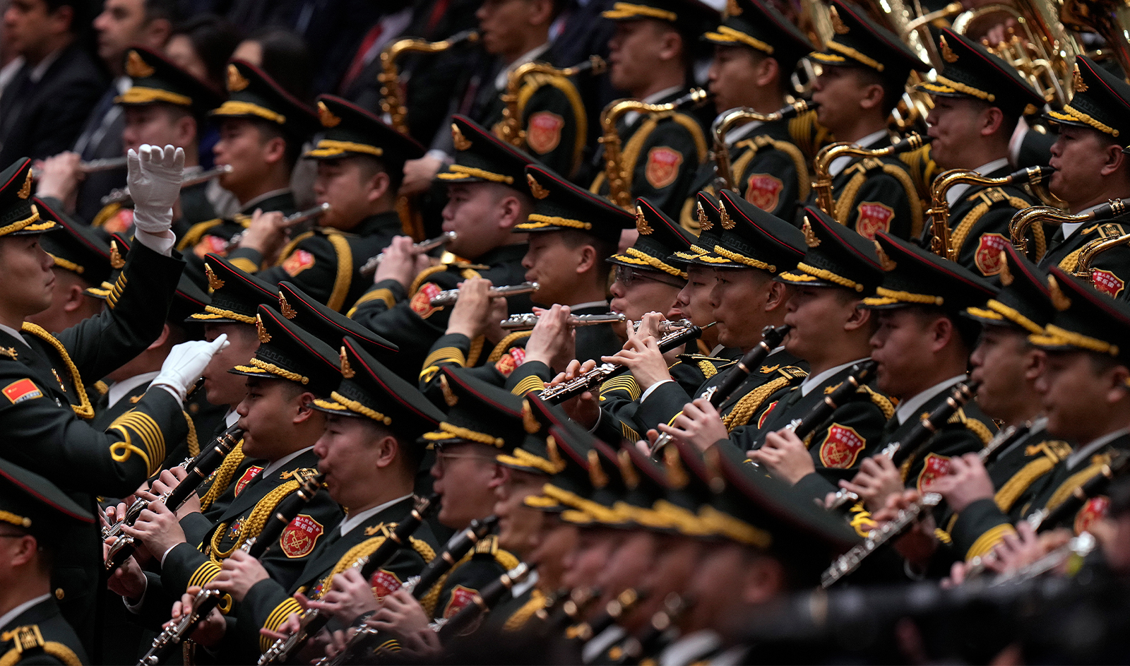 A conductor leads the military band as they perform a national anthem during the opening session of the National People's Congress (NPC) at the Great Hall of the People in Beijing, on March 5, 2024. (AP)