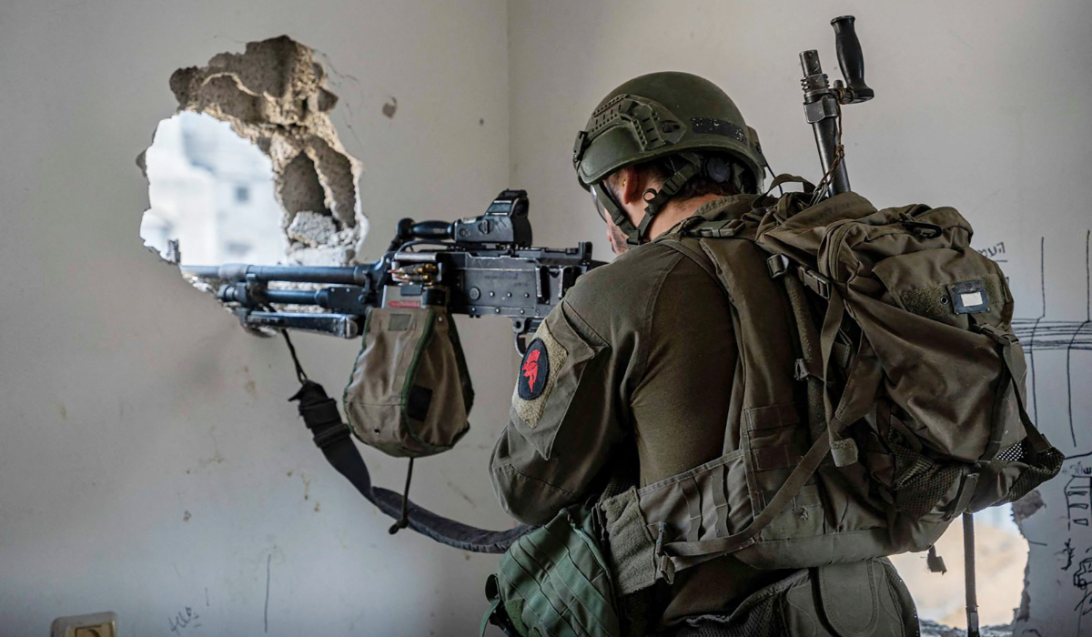 This handout picture released by the Israeli army on March 5, 2024 shows an Israeli soldier aiming his weapon in the Gaza Strip, amid ongoing battles between Israel and the Palestinian militant group Hamas. (AFP)