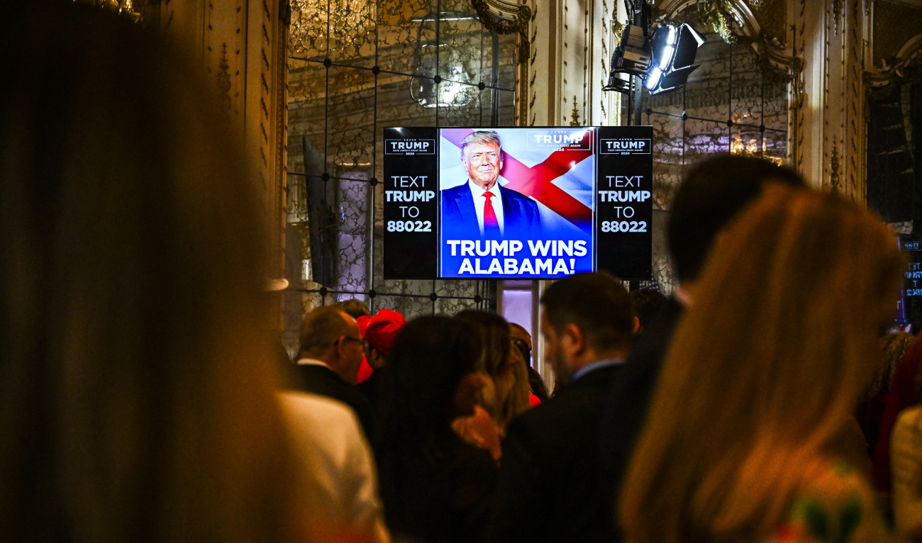 Supporters of former US President and 2024 presidential hopeful Donald Trump watch a screen announcing “Trump wins Alabama” as they attend a Super Tuesday election night watch party at Mar-a-Lago Club in Palm Beach, Florida, on March 5, 2024. (AFP)