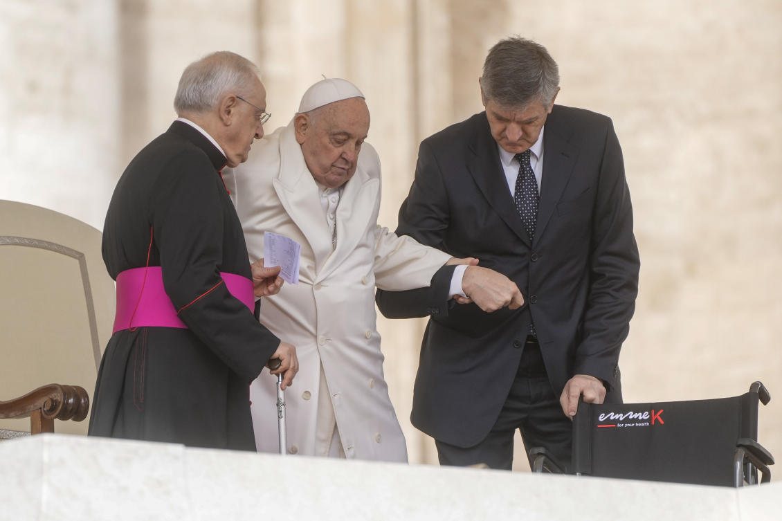 Pope Francis is helped by his aids as he holds his weekly general audience in St. Peter’s Square at the Vatican, on Mar. 6, 2024. (AP)