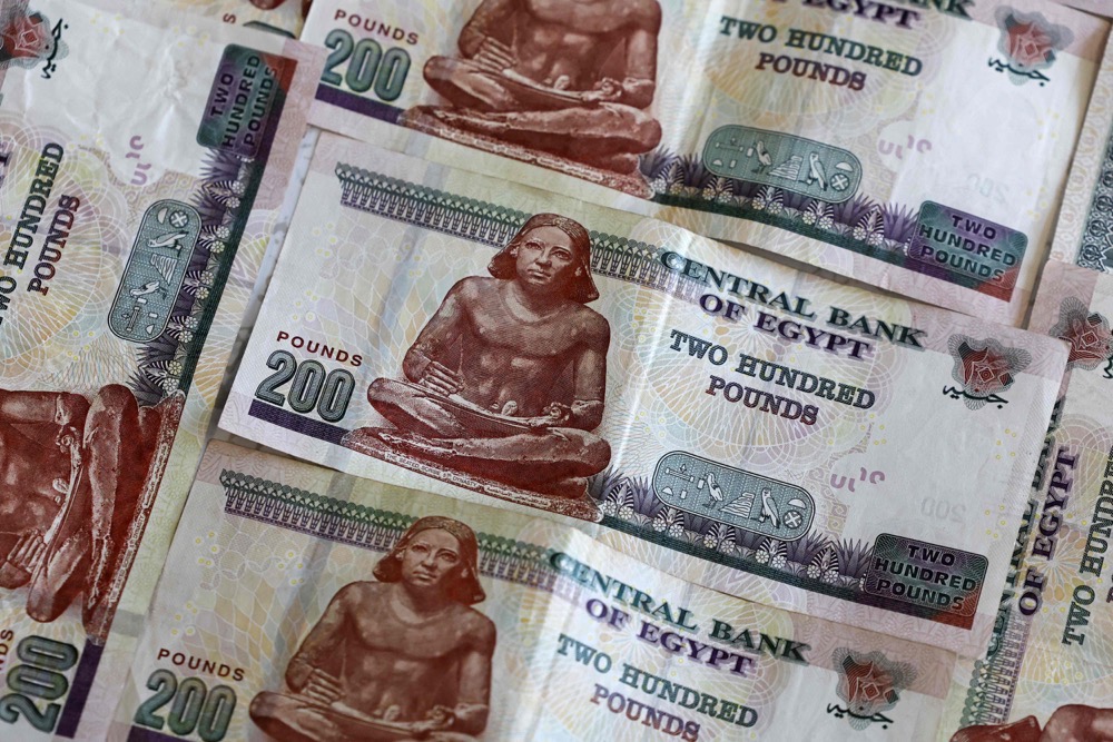 The pound fell to a record low of about 50 to the US dollar, after more than a year of an enforced official exchange rate of about 31. (AFP)