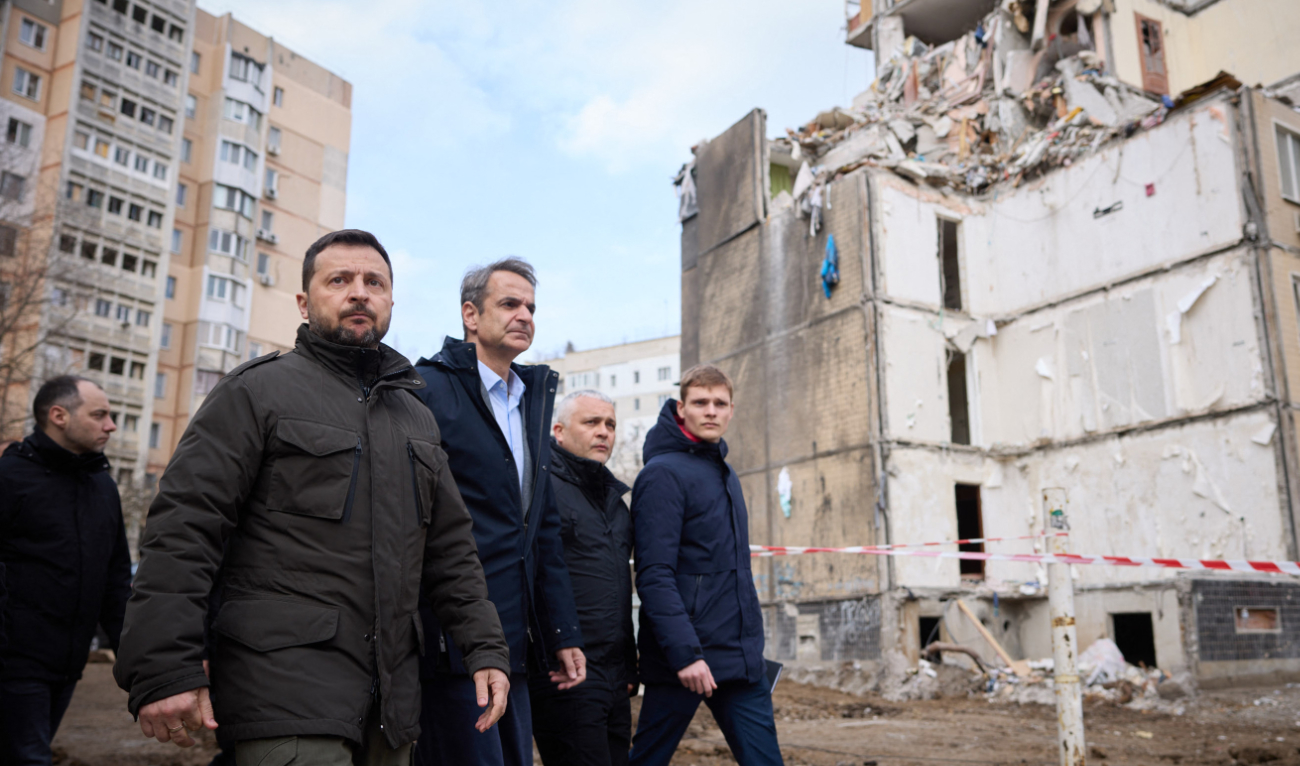 Ukraine’s President Volodymyr Zelensky (2ndL) and Greece’s Prime Minister Kyriakos Mitsotakis (3rdL) walking in front of a residential building damaged as a result of a drone attack in Odesa, on March 6, 2024. (AFP)