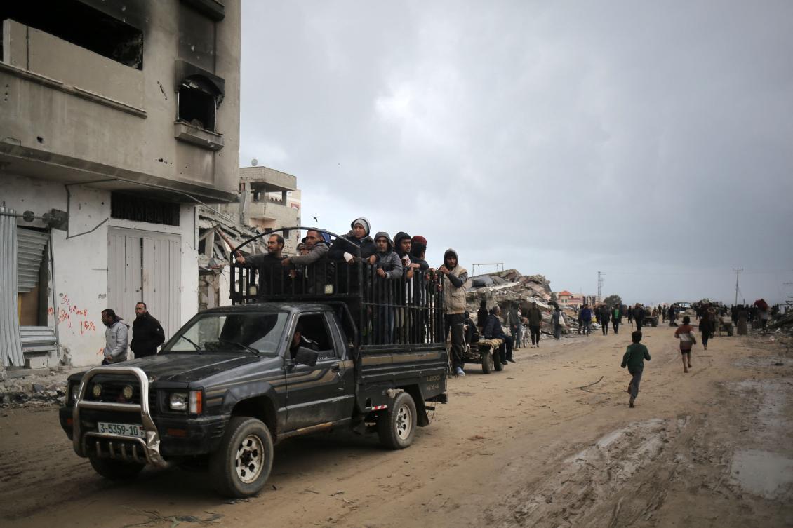 Palestinians ride in the back of a truck as they flee Khan Yunis in the southern Gaza Strip on March 7, 2024. (AFP)